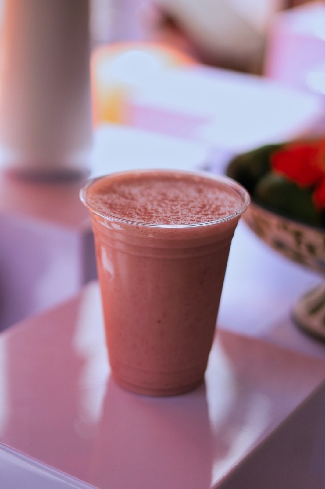 Fresh smoothie in a clear cup at Blend and Bliss Juice Bar